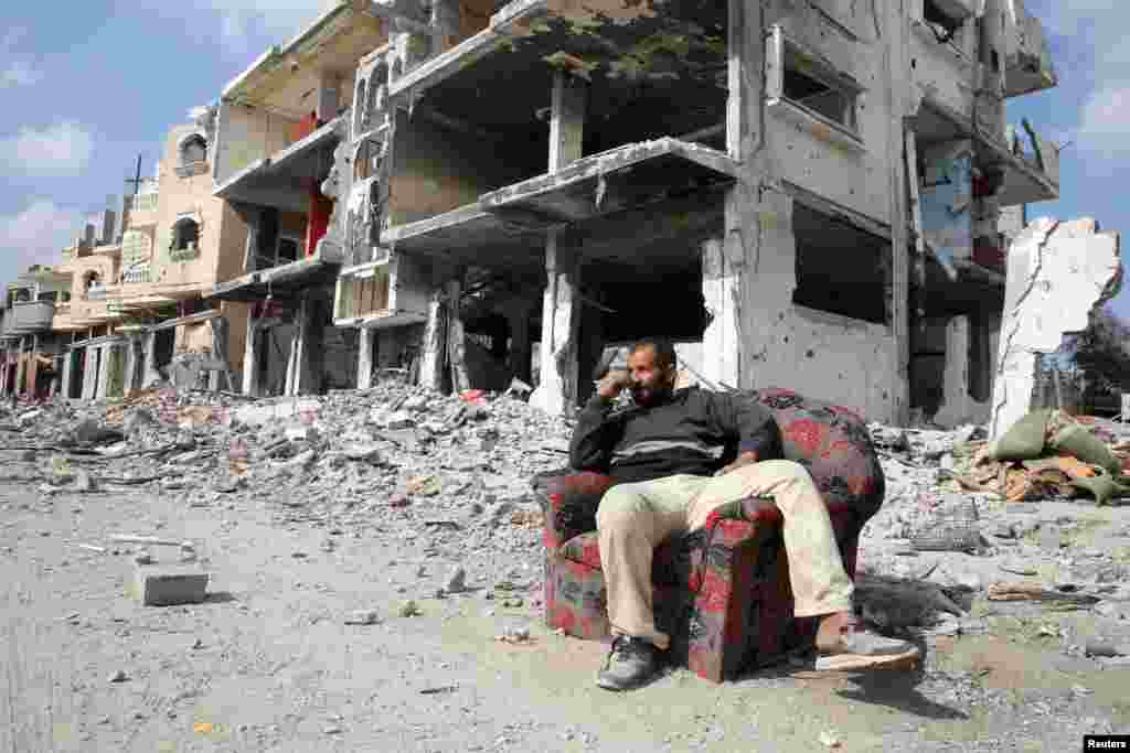 A Palestinian sits among the rubble of buildings destroyed during the Israeli offensive in Rafah in the southern Gaza Strip, Feb. 4, 2025.