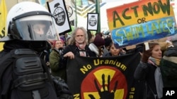 FILE - Climate activists stop in front of the COP24 U.N. Climate Change Conference venue during the March for Climate in a protest against global warming in Katowice, Poland, Dec. 8, 2018. 