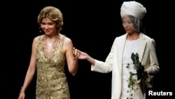 FILE - Gulnara Karimova (L), daughter of Uzbekistan's President Islam Karimov, stands with a model during China Fashion Week, Oct. 30, 2012. 