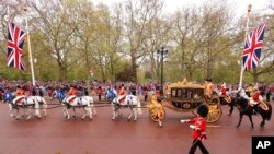 El rey Carlos III de Gran Bretaña y Camilla, la reina consorte, camino a la Abadía de Westminster para su ceremonia de coronación en Londres, el sábado 6 de mayo de 2023. (Richard Heathcote, Pool vía AP)
