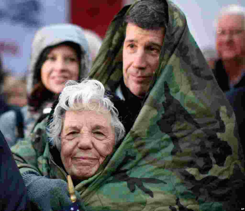 Supporters huddle against the early morning cold waiting to hear Mitt Romney speak at a Hy-Vee grocery store in West Des Moines, Iowa. (AP)