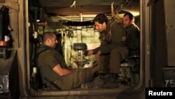 Israeli soldiers in an Armoured Personnel Carrier at a staging area outside the northern Gaza Strip, Nov. 21, 2012.