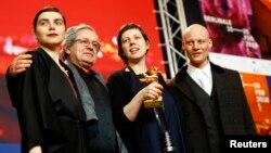 Director, screenwriter, editor and producer Adina Pintilie and cast members pose with the Golden Bear award for best film, "Touch Me Not," at the news conference after the awards ceremony at the 68th Berlinale International Film Festival in Berlin, Germany, Feb. 24, 2018.