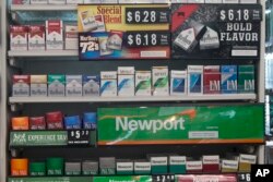 Packs of cigarettes are offered for sale at a convenience store in Helena, Mont., on Thursday, May 18, 2017.