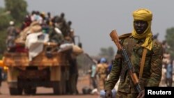 A Chadian soldier, part of the African Union (AU) peacekeeping mission in the Central African Republic, keeps guard during the beginning of a road repatriation to Chad in the capital Bangui, Jan. 22, 2014. 