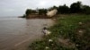 FILE - A Cambodian fisherman takes off his fishing net at Mekong river bank of Koh Norea village in Phnom Penh.