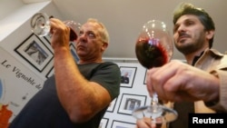 Sandro Saade (R), the owner of Domaine de Bargylus, and French winemaker and consultant Stephane Derenoncourt during a wine tasting session in Beirut, Lebanon, Sept. 3, 2014. 