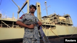 An Iranian soldier stands guard near Iranian Navy helicopter carrier Kharg at Port Sudan at the Red Sea State, October 31, 2012.