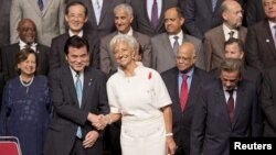 International Monetary Fund (IMF) Managing Director Christine Lagarde shakes hands with Japanese Finance Minister Koriki Jojima before posing for a group photograph in Tokyo, October 12, 2012.