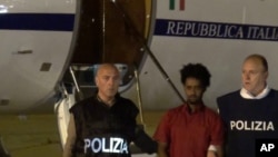 Two weeks after his arrest in Sudan, Italian police escort the man authorities believe is Medhane Yehdego Mered upon his arrival at Ciampino's airport, on the outskirts of Rome, June 7, 2016.
