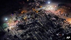 In this aerial photo, a collapsed factory is seen with workers searching for survivors, Dec. 11, 2021, in Mayfield, Ky., after tornadoes came through the area the previous night.