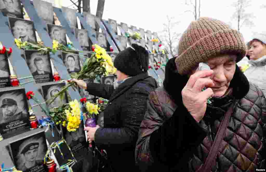 People attend a commemoration ceremony at a monument to the so-called &quot;Heavenly Hundred&quot;, the anti-government protesters killed during the Ukrainian pro-European Union (EU) mass demonstrations in 2014, to mark the fifth anniversary of the start of the uprising in Kyiv, Ukraine.