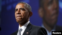 U.S. President Barack Obama pauses while speaking about gun violence during an address to the United States Conference of Mayors in San Francisco, June 19, 2015. 