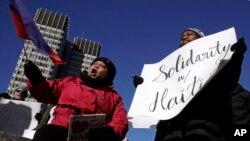 Haitian activists and immigrants protest on City Hall Plaza in Boston, Jan. 26, 2018. Haitian community leaders had complained that the Trump administration's delays in re-registering those living in the U.S. legally through the Temporary Protected Status program would lead to job losses, travel problems and other issues for Haitians.