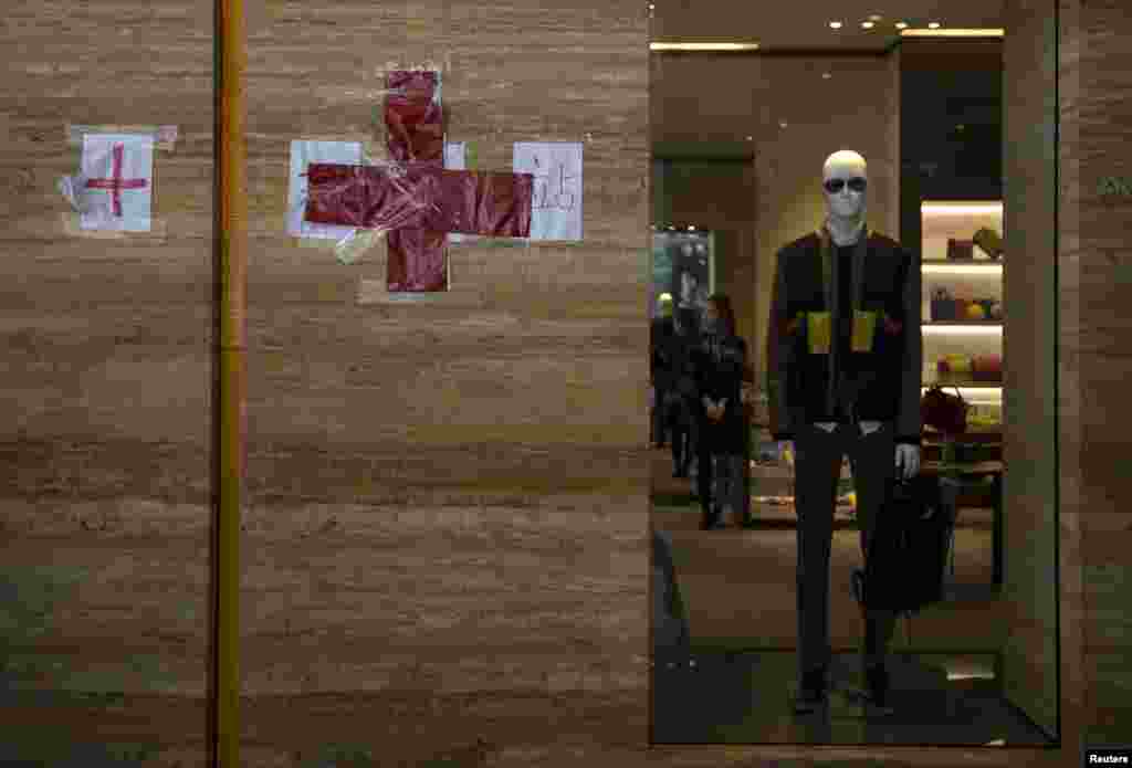 A red cross sign is seen at a first aid station set up by protesters outside a luxury shop along a main street at Hong Kong's Tsim Sha Tsui shopping district, Oct. 1, 2014. 