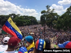 Opponents of President Nicolas Maduro wave a Venezuelan national flag as thousands gather in Caracas, Venezuela, May 20, 2017.