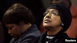 FILE - Winnie Madikizela-Mandela, ex-wife of former South African President Nelson Mandela, and her daughter Zindzi attend a prayer service for the ailing Mandela at a church in Johannesburg, July 5, 2013. 