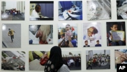 A Bahrain woman looks at pictures of victims of the February 14 uprising, displayed at an exhibition during a gathering held by the Al Fateh Youth Union in Isa Town, south of Manama, Bahrain, July 28, 2011