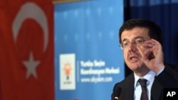 FILE - Turkish Minister of Economic Affairs Nihat Zeybekci speaking inside a hotel in Cologne, Germany.