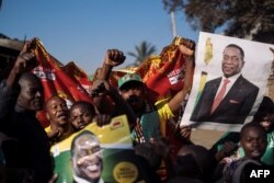 Supporters of the newly elected Zimbabwe President Emmerson Mnangagwa celebrate in Mbare, Harare, Aug. 3, 2018.