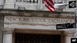 This 2014 file photo shows the Wall Street entrance of the New York Stock Exchange.