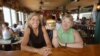 FILE - Cheeseburger in Paradise founders and co-owners Edna Bayliff, left, and Laren Gartner pose with one of their trademark burgers at their Lahaina, Hawaii, restaurant.