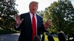 President Donald Trump talks with reporters before departing on Marine One for an Air Force Academy graduation ceremony, May 30, 2019, in Washington.