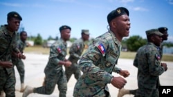FILE - Members of Haiti's new national military force run and chant during training at a former U.N. base in Gressier, Haiti, April 11, 2017.