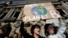 FILE - People hold placards as they attend a protest asking for urgent measures to combat climate change in Paris, France, Feb. 22, 2019. Scientists said Monday that evidence for man-made global warming has reached a "gold standard" level of certainty.