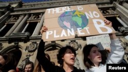 FILE - People hold placards as they attend a protest asking for urgent measures to combat climate change in Paris, France, Feb. 22, 2019. Scientists said Monday that evidence for man-made global warming has reached a "gold standard" level of certainty.