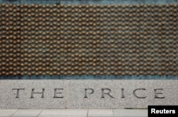 FILE - A portion of the 4,048 gold stars of the Price of Freedom wall is seen at the National World War II Memorial in Washington, June 5, 2014.