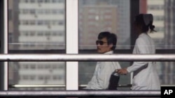 TOPSHOTS
Chinese activist activist Chen Guangcheng (L) is seen in a wheelchair pushed by a nurse at the Chaoyang hospital in Beijing on May 2, 2012. A US official said there would be no repeat of the incident involving the activist Chen Guangcheng, but 