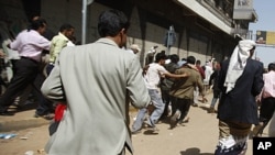 Anti-government protesters flee after security forces opened fire to disperse them in Sana'a, September 19, 2011.