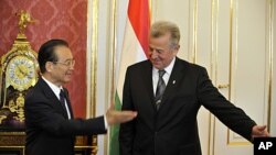 Chinese Prime Minister Wen Jiabao and Hungarian President Pal Schmitt, greet each other before meeting in Budapest, Hungary, June 25, 2011