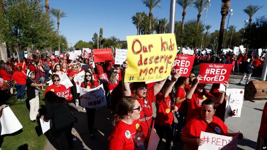 Arizona teachers and education advocates march at the Arizona Capitol highlighting low teacher pay and school funding Wednesday, March 28, 2018, in Phoenix. (AP Photo/Ross D. Franklin)