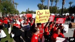 Arizona teachers and education advocates march at the Arizona Capitol highlighting low teacher pay and school funding Wednesday, March 28, 2018, in Phoenix. (AP Photo/Ross D. Franklin)