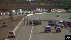 FILE - Traffic backs up on Interstate Highway 10 as authorities investigate the scene of a fatal accident in Phoenix, July 26, 2015. Road deaths rose 7.2 percent to 35,092 in 2015, the highest full-year increase since 1966.