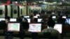 FILE - Customers surf the Internet at an Internet cafe in Beijing, China.