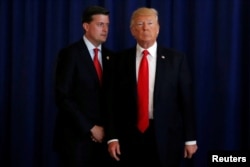 FILE - White House Staff Secretary Rob Porter, left, speaks to U.S. President Donald Trump in Bedminster, New Jersey, Aug.12, 2017.