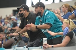 Jacksonville Jaguars fans cheer during the first half of an NFL football game against the Indianapolis Colts, Sunday, Sept. 13, 2020, in Jacksonville, Fla. (AP Photo/Phelan M. Ebenhack)