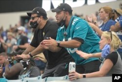 Jacksonville Jaguars fans cheer during the first half of an NFL football game against the Indianapolis Colts, Sunday, Sept. 13, 2020, in Jacksonville, Fla. (AP Photo/Phelan M. Ebenhack)