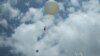 Gary Morris, lead trainer for the NASA ozone balloon project, and the Saint Louis University team launch the weather balloon at the Saint Louis planetarium. (Art Chimes for VOA)