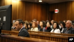 Oscar Pistorius sits in the dock as he listens to cross questioning about the events surrounding the shooting death of his girlfriend Reeva Steenkamp at court during his trial in Pretoria, South Africa, March 10, 2014.