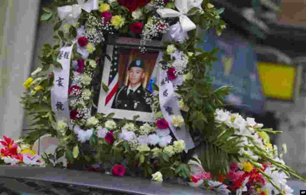 A portrait of Private Danny Chen is displayed on a funeral procession vehicle during the procession on Thursday, Oct. 13, 2011 in New York. (AP Photo/Jin Lee)