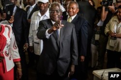 FILE - Afonso Dhlakama, a former Renamo rebel chief turned opposition leader who is seeking the Mozambican presidency for the fifth time, shows his ink-stained finger after casting his ballot at a polling station in Maputo as Mozambicans vote in 2009.