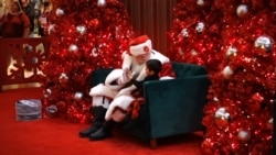 Santa high-five with a little boy during photoshoot with Santa at Macy’s Department Store, December 18, 2021, Springfield, Virginia.