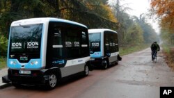 An electric driverless shuttle produced by EasyMile drives, as part of an experiment, in Paris, Friday, Nov. 17, 2017. The full-electric autonomous vehicle is made by French company EasyMile, one of multiple French driverless car projects. (AP Photo/Christophe Ena)