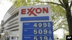 Gas prices above $1.31 per liter ($5 per gallon) are seen on a sign at a gas station in Washington, April 20, 2011
