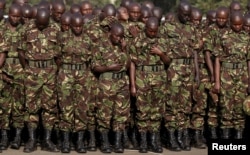 FILE - Members of the Kenya Defense Forces pay respects to the Kenyan soldiers serving in the African Union Mission in Somalia, who were killed during an attack, at a memorial mass at the Moi Barracks in Eldoret, Jan. 27, 2016.