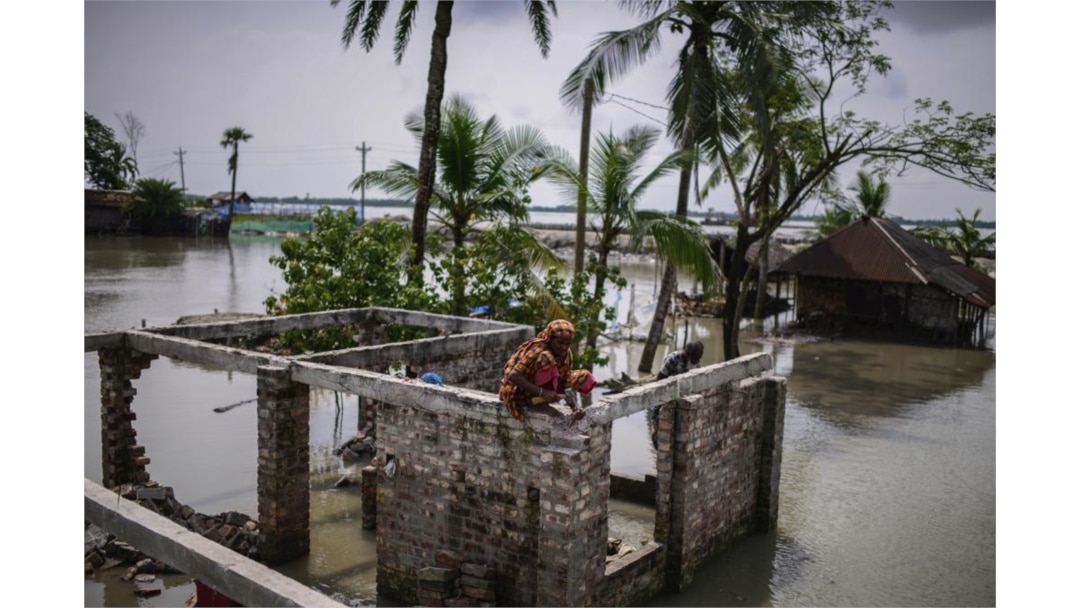 Villagers collect bricks from their house that was destroyed by natural disasters at Pratap Nagar in Satkhira, Bangladesh on Oct. 5, 2021. (AP Photo/Mahmud Hossain Opu)